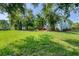 Expansive lawn and lush tropical landscaping creating a private backyard oasis at 200 Capstan Dr, Placida, FL 33946