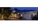 Charming home with a two-car garage, lush landscaping, and walkway to the front door at twilight at 200 Capstan Dr, Placida, FL 33946