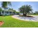 Beautiful home with a circular driveway, lush lawn, and well-maintained landscaping at 200 Capstan Dr, Placida, FL 33946
