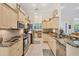 Well-equipped kitchen with granite countertops, custom cabinetry, and stainless steel appliances at 200 Capstan Dr, Placida, FL 33946