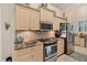 Kitchen with stainless steel appliances, tile backsplash, and granite countertops at 200 Capstan Dr, Placida, FL 33946