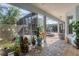 Covered patio with tropical plants, a hot tub, and ample seating space at 200 Capstan Dr, Placida, FL 33946