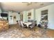 Outdoor dining area with dining table, chairs, brick oven and ceiling fans at 200 Capstan Dr, Placida, FL 33946