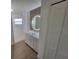 Bathroom features a vanity with wood backsplash, and a frameless glass stand-up shower at 261 Broadmoor Ln, Rotonda West, FL 33947