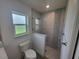 Bathroom with a shower and glass enclosure and tiled accent wall at 261 Broadmoor Ln, Rotonda West, FL 33947