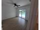 Bedroom with wood-look tile flooring and sliding glass doors to pool at 261 Broadmoor Ln, Rotonda West, FL 33947