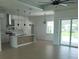 Open-concept kitchen with modern appliances, island, and tile backsplash, seamlessly connecting to living space at 261 Broadmoor Ln, Rotonda West, FL 33947