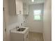 Laundry room features a sink and updated cabinets at 261 Broadmoor Ln, Rotonda West, FL 33947