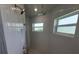Updated shower area with double showerheads and decorative mosaic-tile floor at 261 Broadmoor Ln, Rotonda West, FL 33947