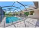 Screened pool and patio area with safety fence at 261 Broadmoor Ln, Rotonda West, FL 33947