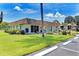 Community building with landscaping, mailbox, and parking at 6 Quails Run Blvd # 7, Englewood, FL 34223