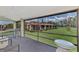 Screened porch with patio furniture and view of the community at 6 Quails Run Blvd # 7, Englewood, FL 34223