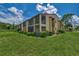 Building exterior showcasing the landscaping and patio areas at 6 Quails Run Blvd # 7, Englewood, FL 34223