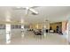 Community room with tables, chairs, and bookcases at 6 Quails Run Blvd # 7, Englewood, FL 34223