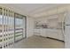 Kitchen with white cabinets, appliances, and a view at 6 Quails Run Blvd # 7, Englewood, FL 34223