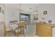 Dining area with a table, chairs, and kitchen access at 6 Quails Run Blvd # 7, Englewood, FL 34223