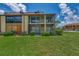 Condo building with screened balconies and landscaping at 6 Quails Run Blvd # 7, Englewood, FL 34223