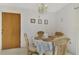 Cozy dining area with a round table and four chairs at 6 Quails Run Blvd # 7, Englewood, FL 34223