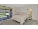 Bedroom with a double bed and sliding glass doors leading to a patio at 6 Quails Run Blvd # 7, Englewood, FL 34223