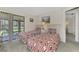 Guest bedroom with two twin beds and access to a private patio at 6 Quails Run Blvd # 7, Englewood, FL 34223