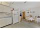 White kitchen cabinets and appliances with tiled floor at 6 Quails Run Blvd # 7, Englewood, FL 34223