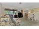 Relaxing living room with ample seating, large windows, and view to backyard at 6 Quails Run Blvd # 7, Englewood, FL 34223