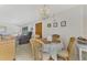 Dining area with a round table and wicker chairs at 6 Quails Run Blvd # 7, Englewood, FL 34223