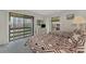 Guest bedroom with two twin beds and patio access at 6 Quails Run Blvd # 7, Englewood, FL 34223