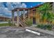 Exterior view of building with stairs and landscaping at 6 Quails Run Blvd # 7, Englewood, FL 34223