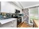 Modern kitchen with stainless steel appliances and blue glass tile backsplash at 624 Blackburn Blvd, North Port, FL 34287