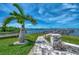 Brick pathway leading to waterfront with palm trees at 53 W Bay Heights Rd # 205, Englewood, FL 34223