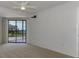 Spacious bedroom with carpeting and sliding glass doors to balcony at 53 W Bay Heights Rd # 205, Englewood, FL 34223