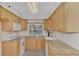 Bright kitchen with granite countertops and wood cabinets at 53 W Bay Heights Rd # 205, Englewood, FL 34223