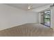 Spacious bedroom with carpeting and sliding glass doors to balcony at 53 W Bay Heights Rd # 205, Englewood, FL 34223