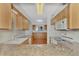 Kitchen with granite countertops and wood cabinets at 53 W Bay Heights Rd # 205, Englewood, FL 34223
