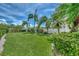 Landscaped backyard with lush grass and tropical plants at 53 W Bay Heights Rd # 205, Englewood, FL 34223