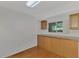 Kitchen features wood cabinets and a window at 53 W Bay Heights Rd # 205, Englewood, FL 34223