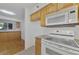 Kitchen features granite countertops and wood cabinets at 53 W Bay Heights Rd # 205, Englewood, FL 34223