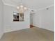 Dining room with kitchen pass-through and chandelier at 53 W Bay Heights Rd # 205, Englewood, FL 34223