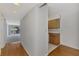 Hallway with wood floors, kitchen access, and light walls at 53 W Bay Heights Rd # 205, Englewood, FL 34223