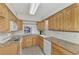 Bright kitchen with granite countertops and wood cabinets at 53 W Bay Heights Rd # 205, Englewood, FL 34223