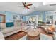 Living room with hardwood floors, a sectional sofa, and French doors leading to the pool at 1730 Padre Ln, Englewood, FL 34223