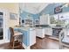 Bright kitchen with granite countertops, white cabinets, and stainless steel appliances at 1730 Padre Ln, Englewood, FL 34223