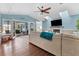 Spacious living room with hardwood floors, vaulted ceilings, and access to the pool area at 1730 Padre Ln, Englewood, FL 34223