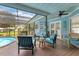Relaxing screened pool area with wooden deck and seating at 1730 Padre Ln, Englewood, FL 34223