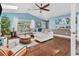 Open living room with hardwood floors, comfortable seating, and plenty of natural light at 1730 Padre Ln, Englewood, FL 34223