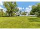 Large grassy backyard with detached building at 1730 Padre Ln, Englewood, FL 34223