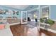 Living area showcasing French doors that open to a view of the refreshing pool at 1730 Padre Ln, Englewood, FL 34223