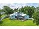 Back of house with pool and hot tub; lush landscaping at 1730 Padre Ln, Englewood, FL 34223