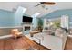 Bright living room boasts hardwood floors, a cozy seating area, and a fireplace at 1730 Padre Ln, Englewood, FL 34223